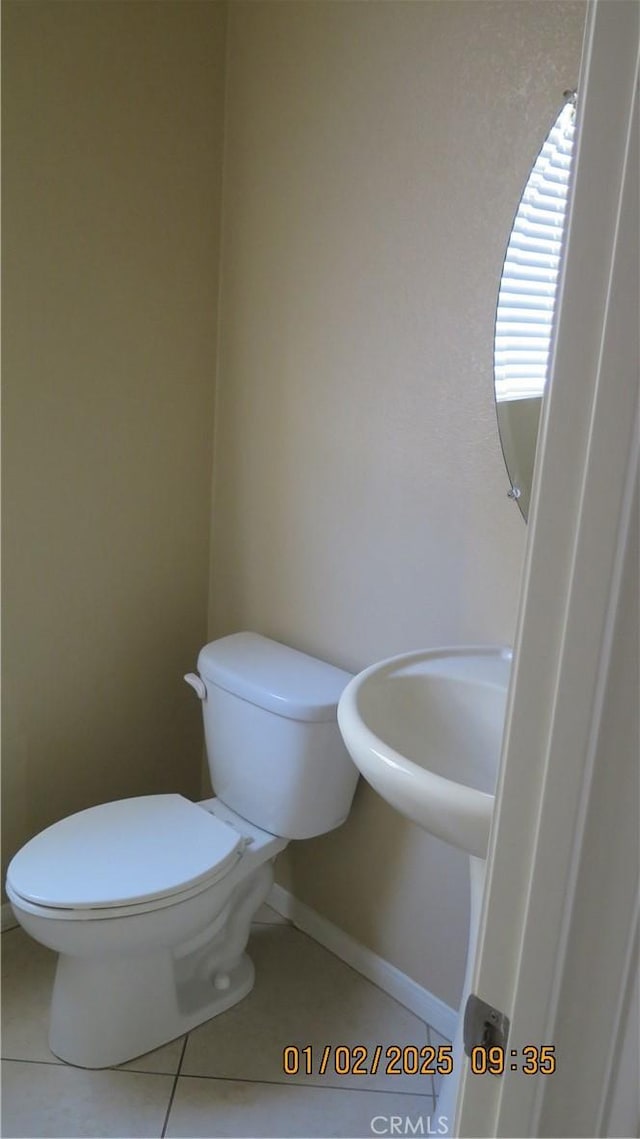 bathroom featuring tile patterned flooring and toilet