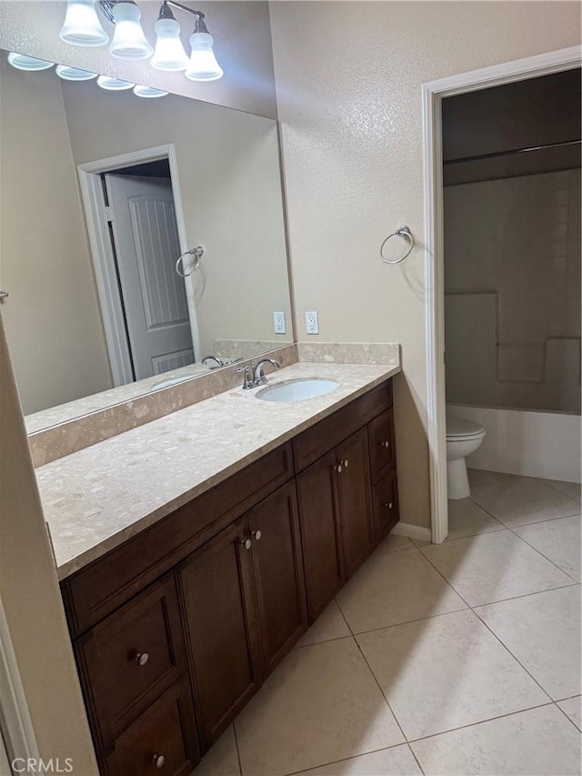 bathroom with tile patterned flooring, vanity, and toilet