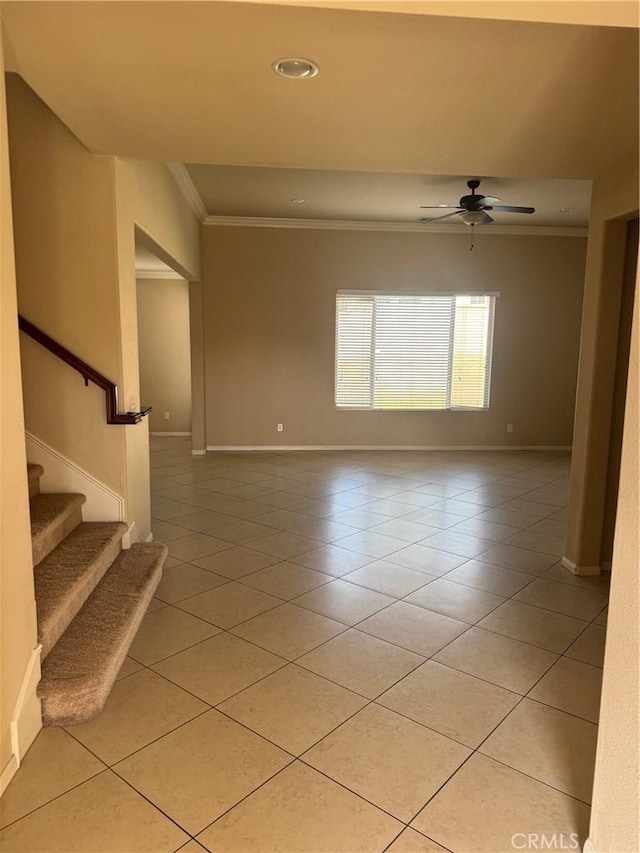 empty room with ornamental molding, light tile patterned floors, and ceiling fan