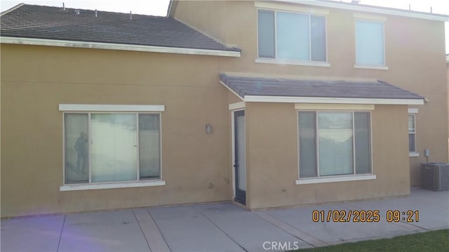 back of house with central AC unit and a patio