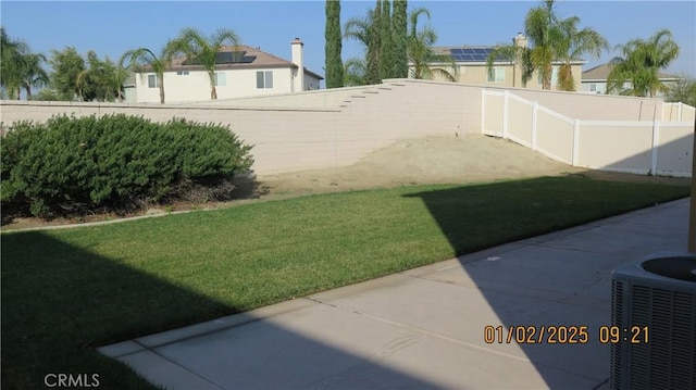 view of yard featuring central AC unit and a patio area