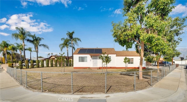 view of front of property featuring solar panels