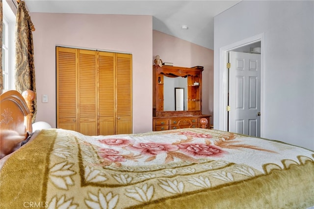 bedroom featuring vaulted ceiling and a closet