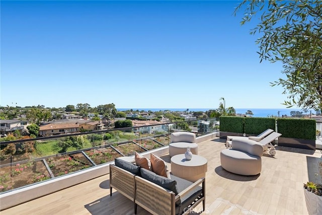 view of patio with a water view, a balcony, and an outdoor hangout area