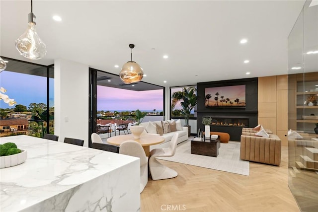 interior space featuring a wall of windows, a fireplace, and light parquet floors