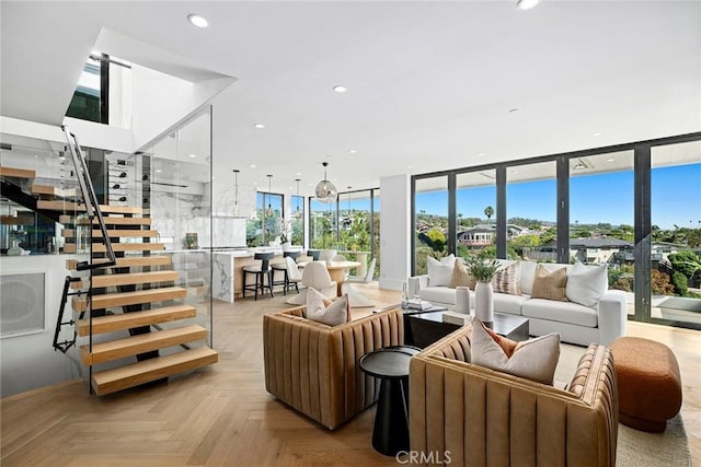 living room featuring a healthy amount of sunlight, floor to ceiling windows, and light parquet flooring