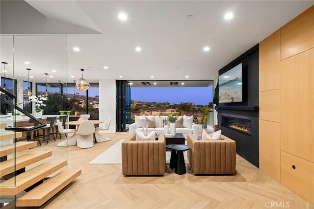 living room with light parquet floors and a fireplace