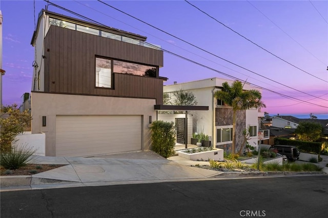 contemporary home featuring a garage and a balcony