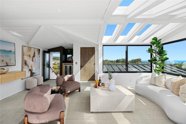 sunroom featuring lofted ceiling with skylight