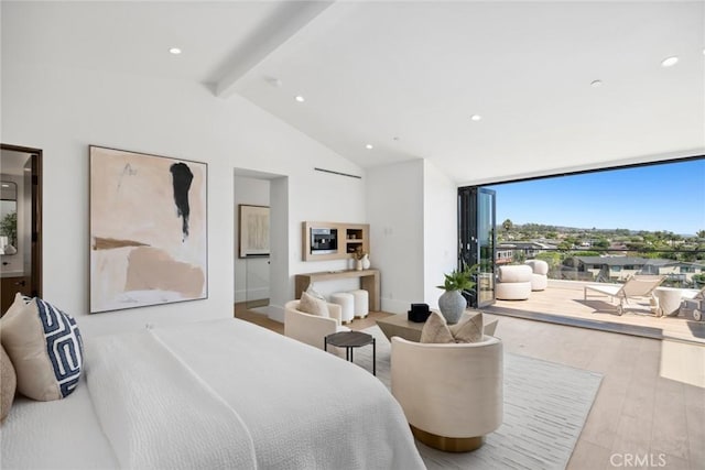bedroom with floor to ceiling windows, light hardwood / wood-style floors, and vaulted ceiling with beams