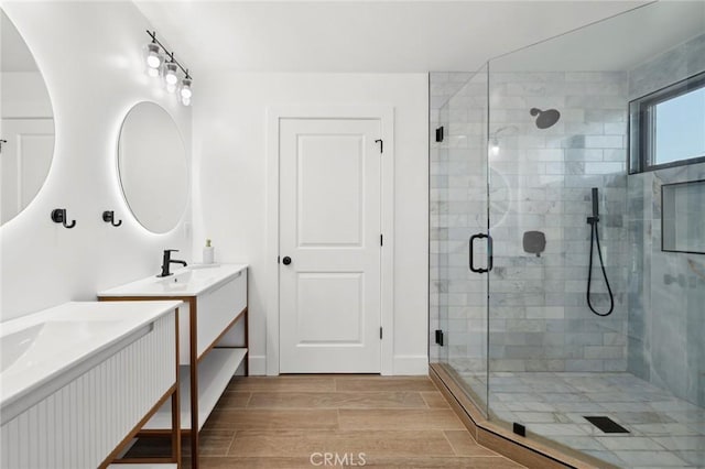 bathroom featuring walk in shower and vanity