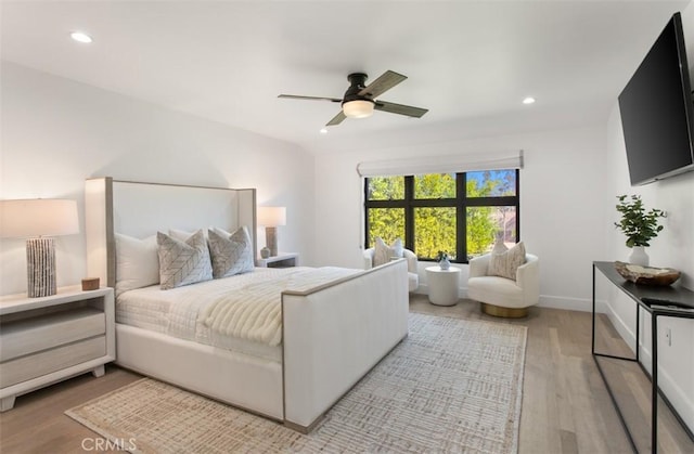 bedroom featuring baseboards, light wood-type flooring, recessed lighting, and a ceiling fan