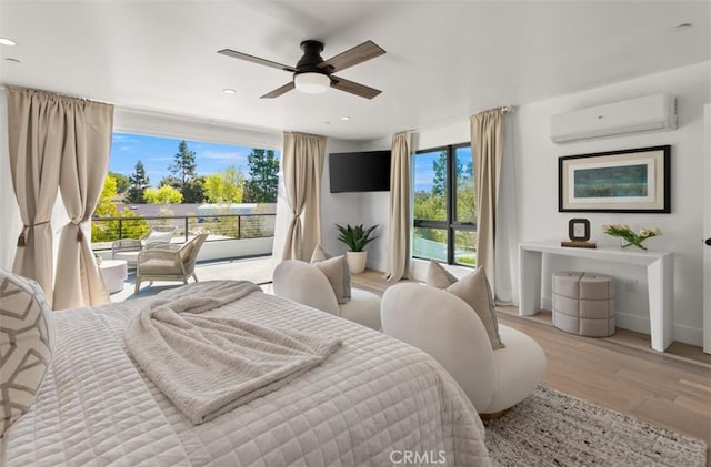 bedroom with recessed lighting, access to exterior, wood finished floors, a wall mounted air conditioner, and baseboards