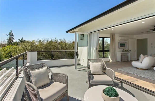 balcony featuring a wall mounted air conditioner and a ceiling fan