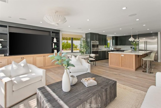 living room featuring recessed lighting and light wood finished floors