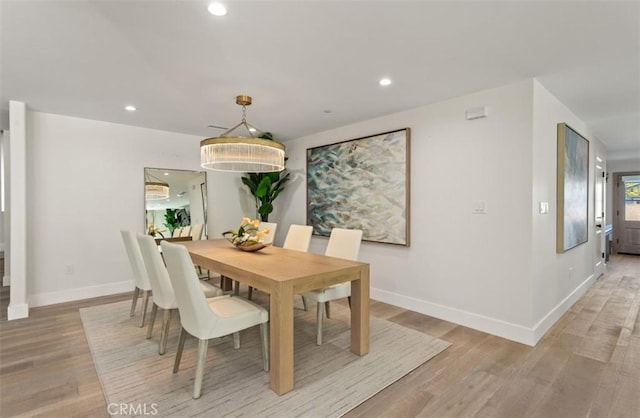dining space with recessed lighting, light wood-style flooring, and baseboards
