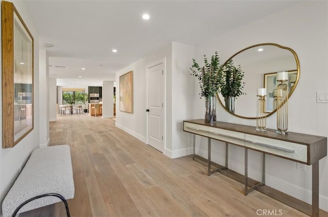 hallway featuring recessed lighting, baseboards, and wood finished floors