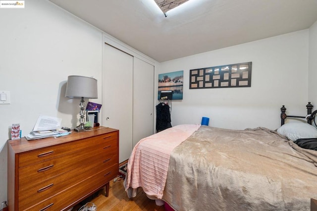 bedroom with a closet and light wood-type flooring