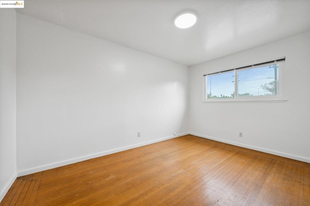 empty room with hardwood / wood-style floors