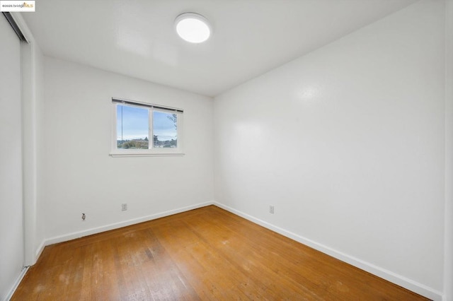 spare room with hardwood / wood-style floors