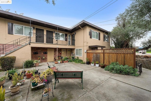 rear view of property featuring a patio