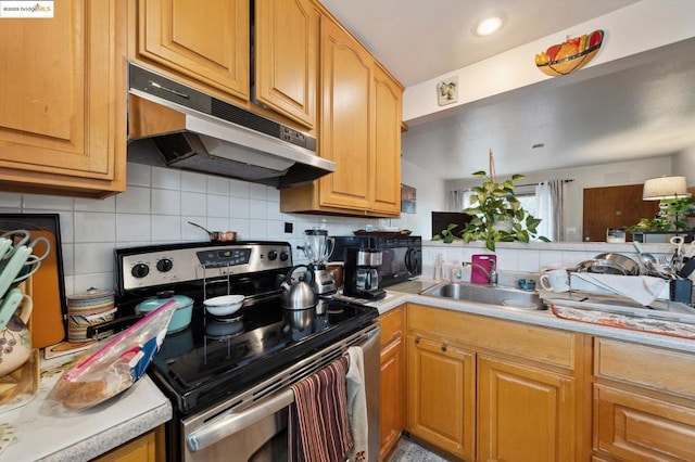 kitchen featuring electric stove, sink, and decorative backsplash