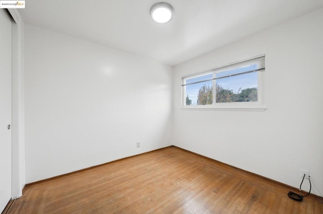 unfurnished room featuring wood-type flooring