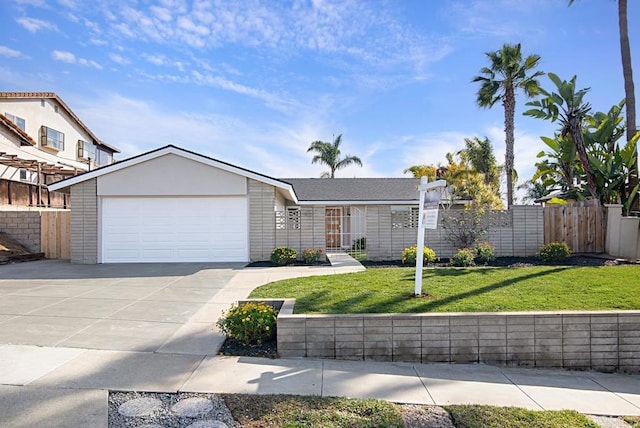 view of front of house with a garage, driveway, a front lawn, and fence