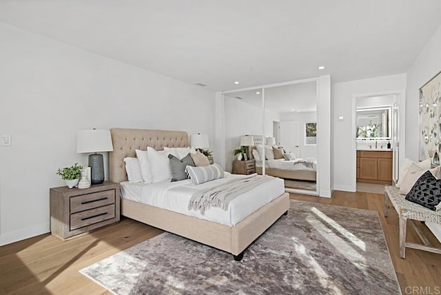 bedroom featuring recessed lighting, baseboards, and light wood finished floors