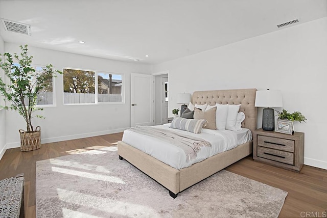 bedroom featuring recessed lighting, visible vents, baseboards, and wood finished floors