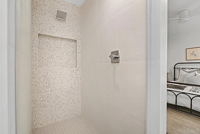 bathroom featuring visible vents and a tile shower