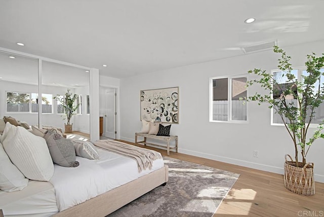 bedroom featuring light wood-type flooring, baseboards, and recessed lighting