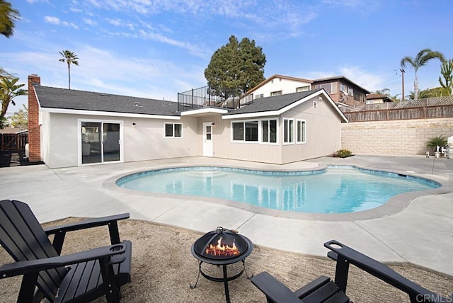 view of pool with a fenced in pool, an outdoor fire pit, fence, and a patio