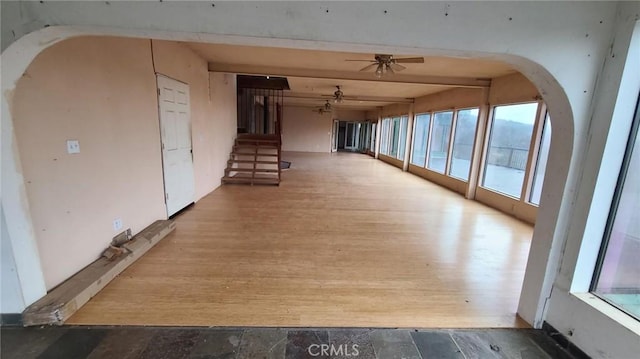 hall with wood-type flooring and beamed ceiling