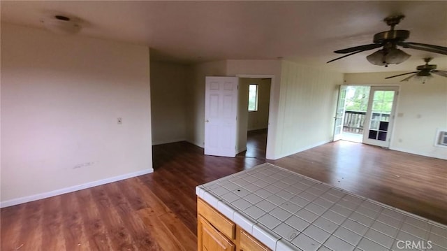 interior space featuring dark wood-type flooring and ceiling fan