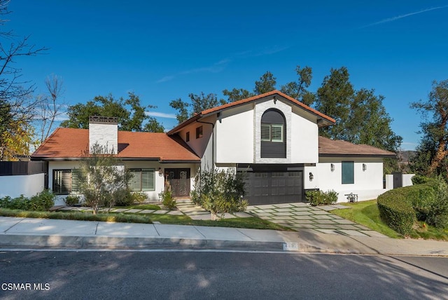 mediterranean / spanish-style home featuring a garage