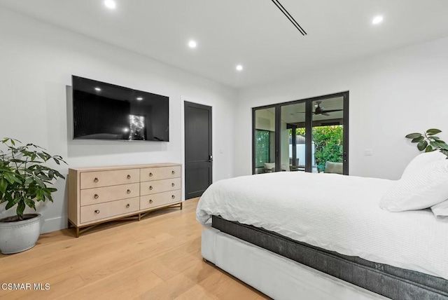 bedroom with access to exterior and light hardwood / wood-style floors