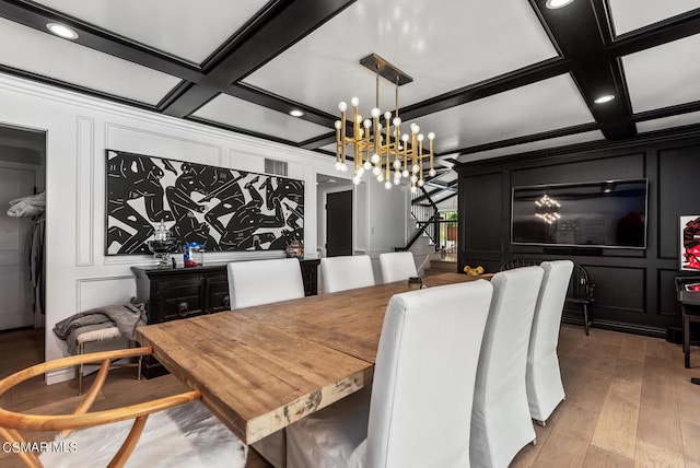 dining area with beamed ceiling, ornamental molding, coffered ceiling, and light hardwood / wood-style flooring