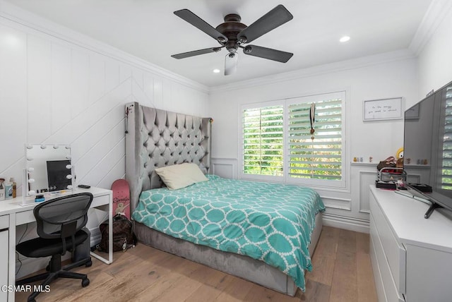 bedroom featuring ceiling fan, ornamental molding, and light hardwood / wood-style floors