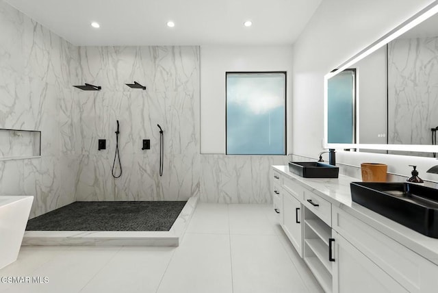 bathroom with tile walls, vanity, and a tile shower