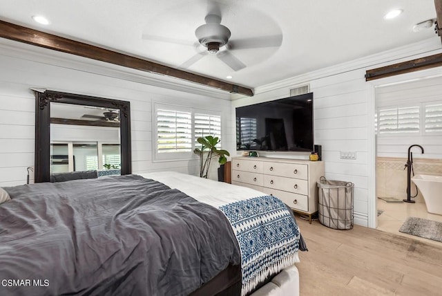 bedroom with light hardwood / wood-style floors, ceiling fan, and wood walls