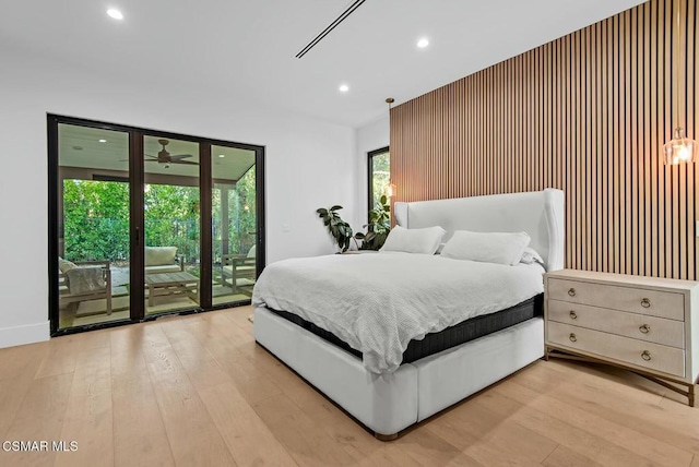 bedroom with access to exterior and light wood-type flooring