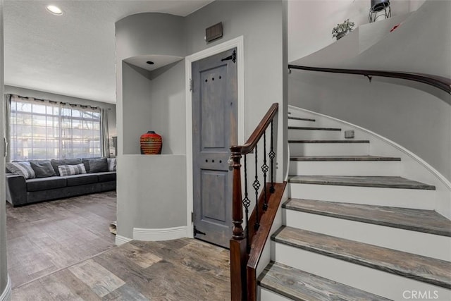 staircase with hardwood / wood-style flooring