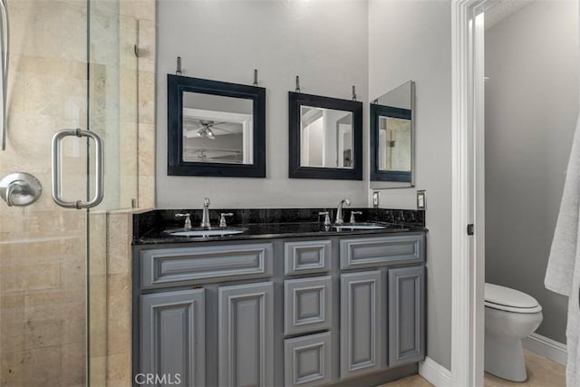 bathroom with walk in shower, vanity, and toilet