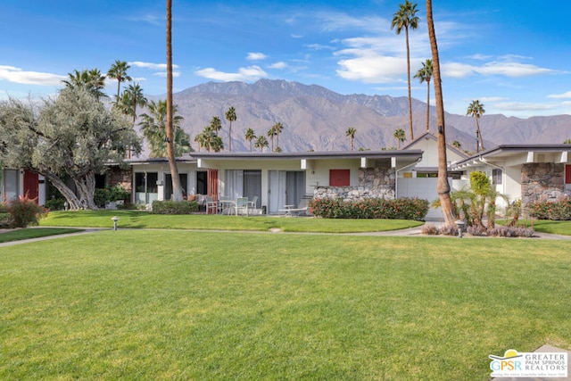 ranch-style house with a mountain view and a front yard