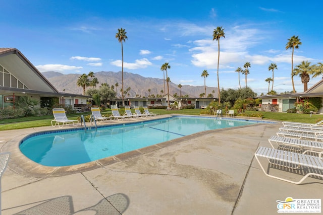 view of pool with a mountain view and a patio