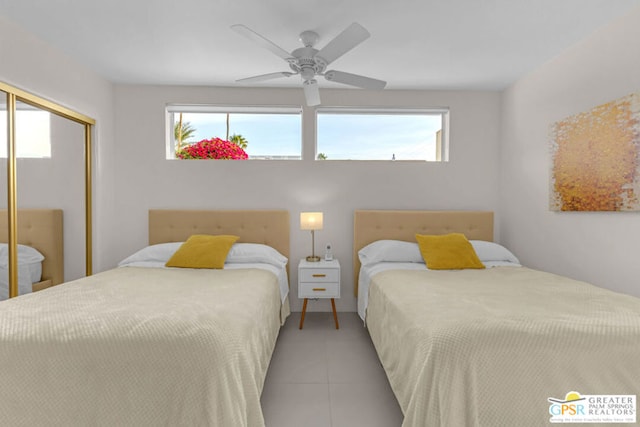 tiled bedroom with a closet and ceiling fan