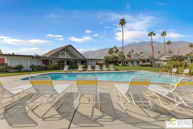 view of pool featuring a mountain view and a patio