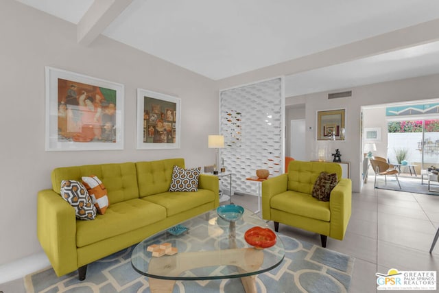 living room featuring beamed ceiling and light tile patterned floors