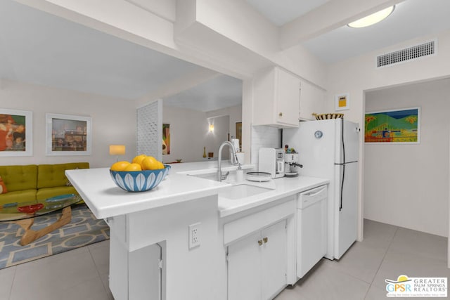 kitchen with white cabinetry, light tile patterned floors, white appliances, and kitchen peninsula